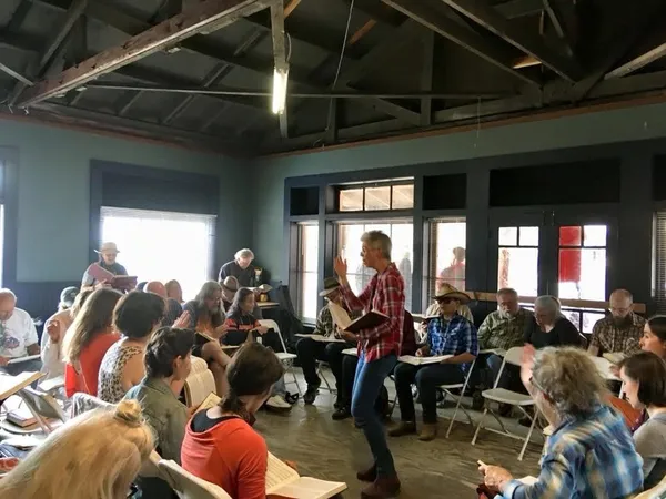 A leader leads a class from the hollow square.